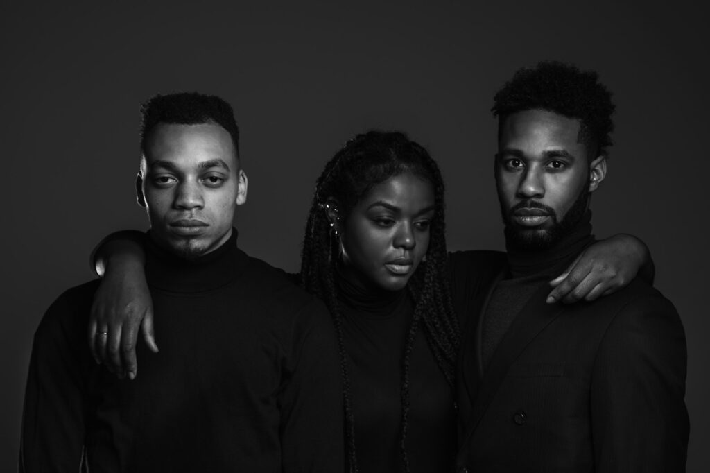 Three young Black creatives standing together