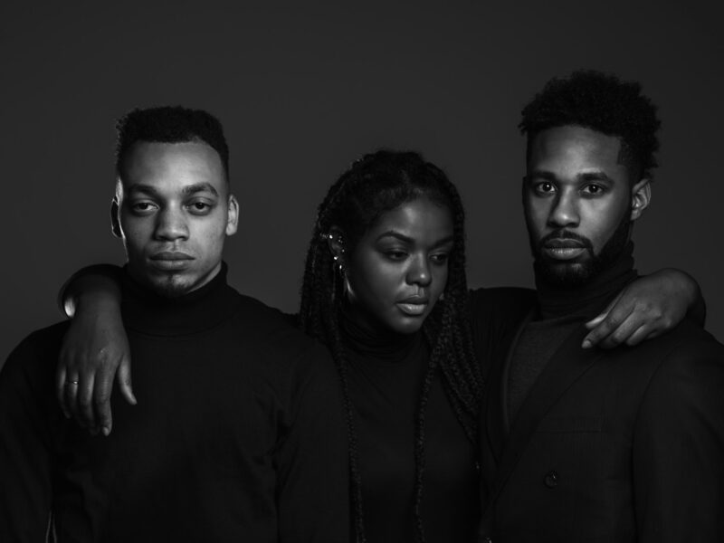 Three young Black creatives standing together