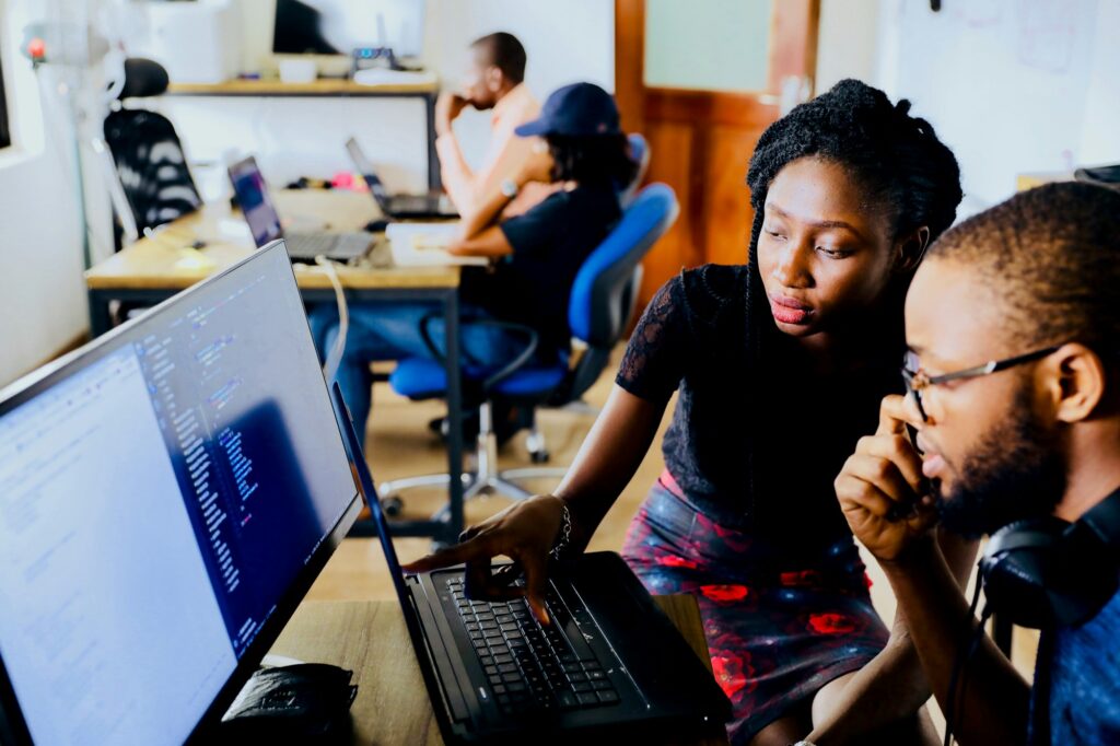 Two young creatives editing on a computer