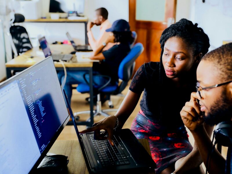Two young creatives editing on a computer