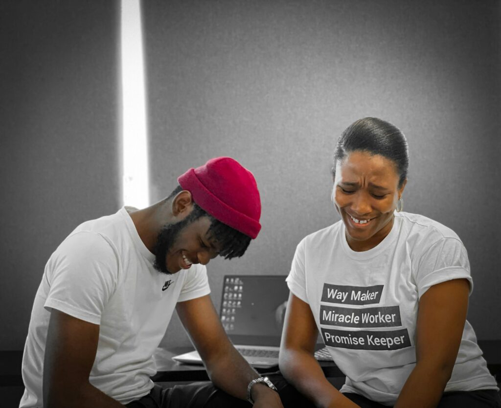 Two collaborators laughing while working together