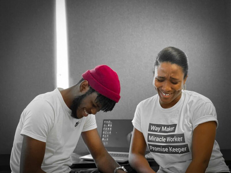 Two collaborators laughing while working together